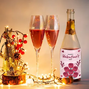 Valentine's Day wine bottle labels with pink rose design and champagne glasses