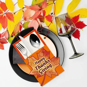 Happy Thanksgiving cutlery holder featuring orange maple leaf design on an elegant table setting