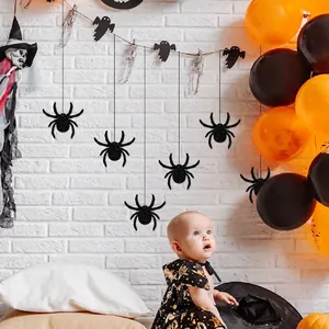 Halloween baby photo scene with spider bat banners and orange black balloons décor