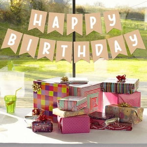 Detail of Happy Birthday kraft paper banner with colorful gift boxes for party decoration