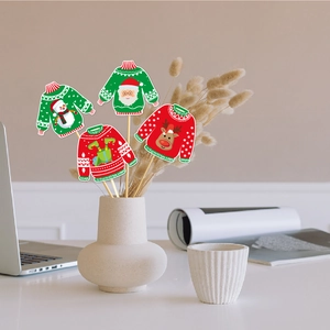 Close-up of four ugly sweater Christmas vase toppers in red and green festive colors