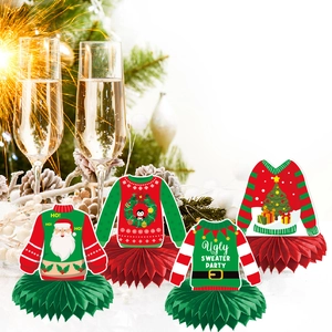 Close-up of four 3D honeycomb centerpieces with festive ugly sweater party paper cutouts