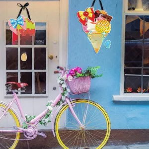 Detail of Hello Summer ice cream wooden hanging ornaments on a bright beach house wall