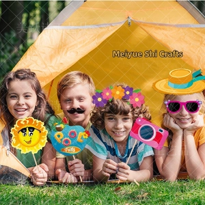 Group of children holding colorful summer pool party photo booth props in a tent