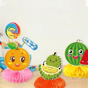 Fruit themed honeycomb table centerpieces with cartoon watermelon and orange for parties
