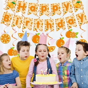Kids celebrating with Happy Birthday orange theme party banners and spiral decorations