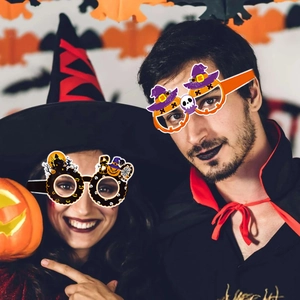 Halloween party paper glasses featuring pumpkin skull and boo designs for photo props