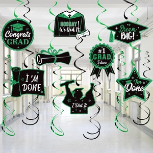 Graduation party decorations featuring black and green foil swirls with festive hanging tags