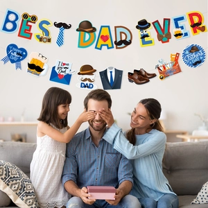 Best Dad Ever Father's Day party banner and hanging swirls set in a cozy family home scene