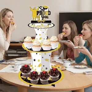 Three-tier graduation cake stand with black gold star patterns and So Proud of You topper
