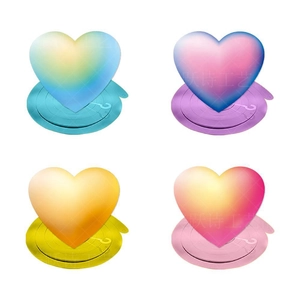 Detailed view of four colorful gradient heart-shaped spiral party decorations