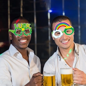 Men wearing festive St. Patrick's Day paper glasses with shamrocks and luck design