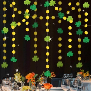 Glittery green clovers and gold dots hanging banner for St. Patrick's Day party decor