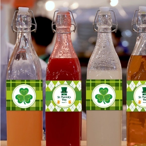 Set of four St. Patrick's Day glass bottles with clover labels and swing top lids