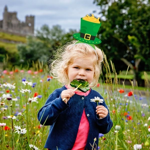 Saint Patrick's Day headband with green leprechaun hat and glitter gold coin decor