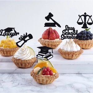Law school graduation cake toppers featuring black glitter law symbols and lawyer quotes