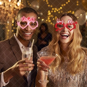 Detail of Kiss Me and Hug Me themed party glasses used as fun Valentine's photo booth props