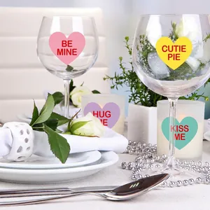 Valentine heart stickers on glass wine cup and frosted candle holder set for romance