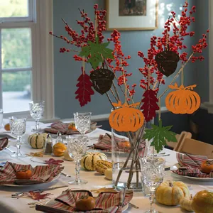 Thanksgiving felt ornaments set with pumpkin and maple leaf hanging on autumn branches