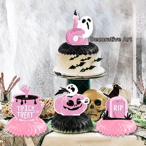 Pink and black Halloween honeycomb centerpieces with pumpkins and ghost decorations