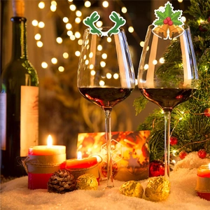 Set of 2 Christmas wine glasses featuring festive reindeer and holly patterns in a warm scene