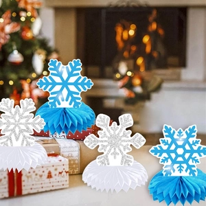 Close-up of blue and silver glitter snowflake honeycomb centerpieces for winter party decor