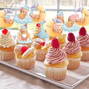 Cute bear baby shower cupcake toppers with clouds and moon on white cream desserts