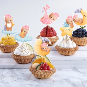Cute bear themed cake toppers for baby shower party decorations on assorted fruit tarts
