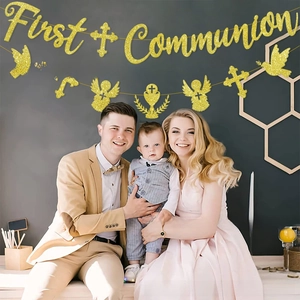 Detail of glitter First Communion party banner with religious crosses and angel motifs