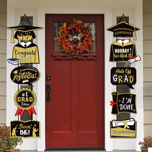 Classic black and gold Congrats Grad porch signs hanging on front door for graduation party