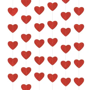 Close-up of glittery red heart hanging garlands for romantic Valentine wedding party decoration