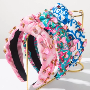 Close-up of bohemian tie-dye knotted headbands with colorful crystals and pearls