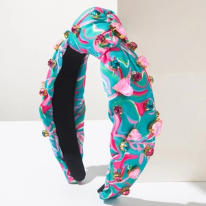 Close-up of bohemian tie-dye headband with hand-sewn pink and blue rhinestones