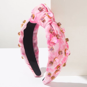Detail of pink tie-dye knotted headband with sparkling heart-shaped rhinestones