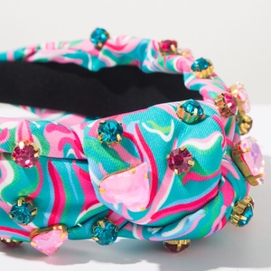 Close-up of knot detail on tie-dye headband with colorful rhinestones and velvet lining