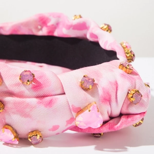 Close-up of tie-dye fabric headband with pink crystals and golden metal claw settings