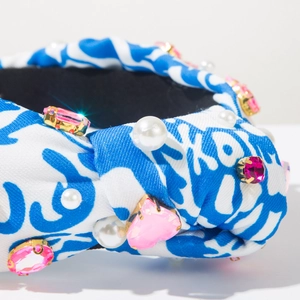 Detail of knot headband featuring blue tie-dye fabric with pink rhinestones and pearls