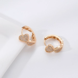 Detailed view of gold plated heart drop earrings with shimmering micro-pave zircons