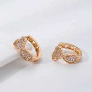 Exaggerated gold bow earrings with micro-pave zircons and geometric metal design