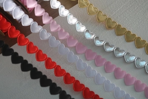 Detailed view of multi-colored heart-shaped ribbon trims for gift wrapping and DIY crafts