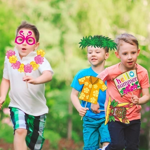 Hawaiian beach party photo booth props with summer themed masks and tropical accessories