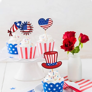 Patriotic July 4th cupcake toppers and wrappers with American flag patterns on a white stand
