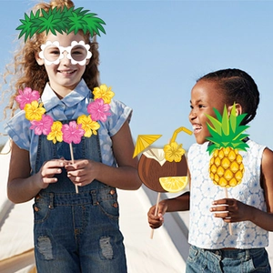 Hawaiian Tiki party photo booth props with tropical masks and summer themed accessories