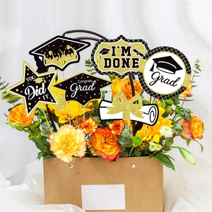 Detail of graduation party floral picks with glittery Congrats Grad signs in a bouquet