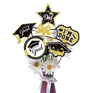 Black and gold glitter graduation party centerpiece sticks in flower vase decoration