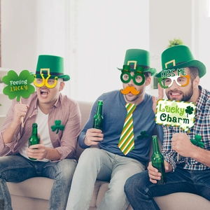 Three men having fun using green St. Patrick's Day photo booth props in a lively party scene