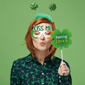 Close-up of St. Patrick's Day prop set with clover headband, glasses, and lucky sign