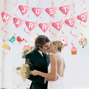Just Married pink wedding banner with spiral hanging swirl decorations for party venues