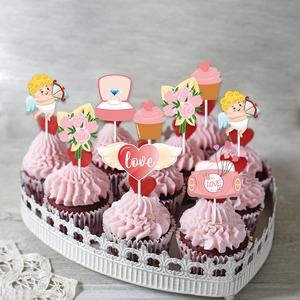 Macro shot of romantic Valentine cake toppers featuring Cupid and heart icons on velvet cupcakes