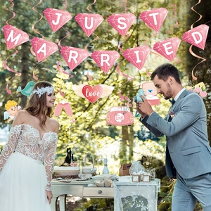 Pink Just Married diamond bunting and wedding hanging swirls set in a forest venue